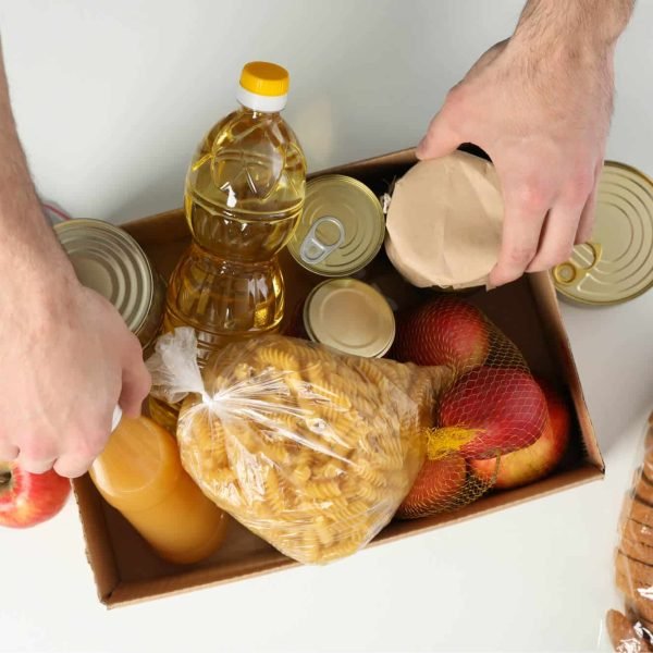 young-man-puts-groceries-in-donation-box-voluntee-2021-09-02-21-35-53-utc.jpg